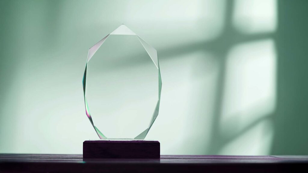 close up of crystal trophy against gray background