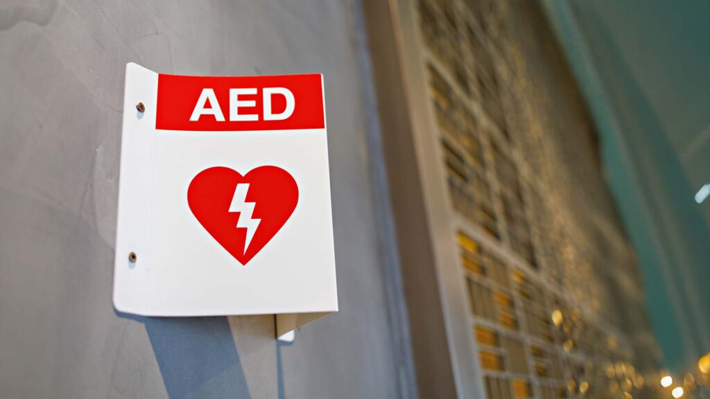 Close of Automated External Defibrillator (AED) sign on a wall
