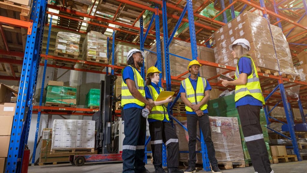 group of people worker in warehouse cargo storage meeting talking together work discussion with foreman manager for planning teamwork working