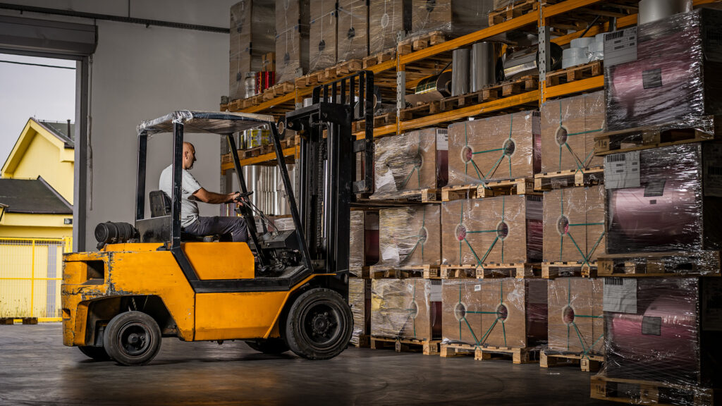 Warehouse worker driving a forklift