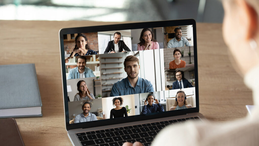 Close up rear view of a woman out of focus engaged in an online meeting